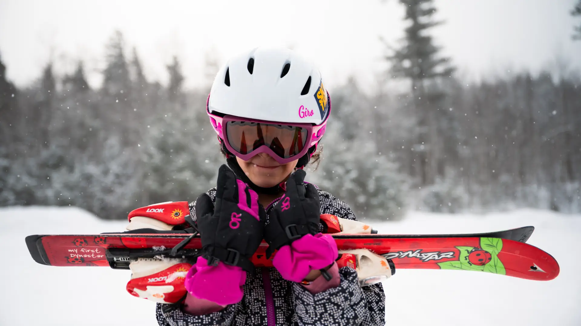 A child carrying skis.
